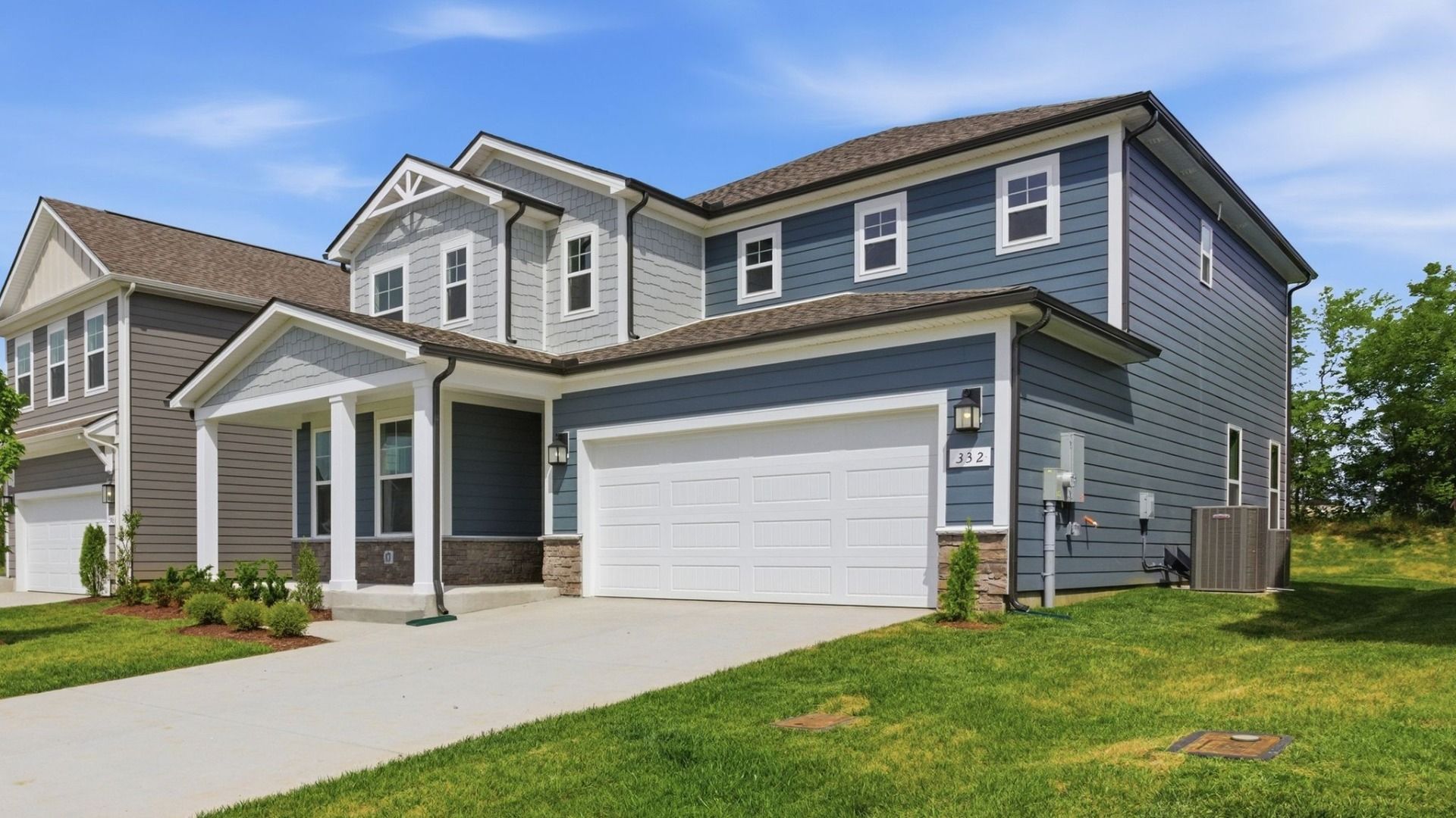 Home exterior with blue siding and two car garage
