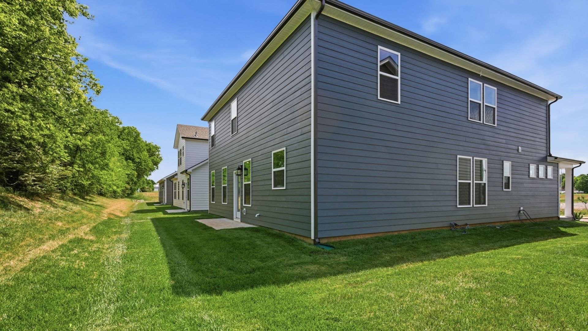 Backyard of home with small back patio