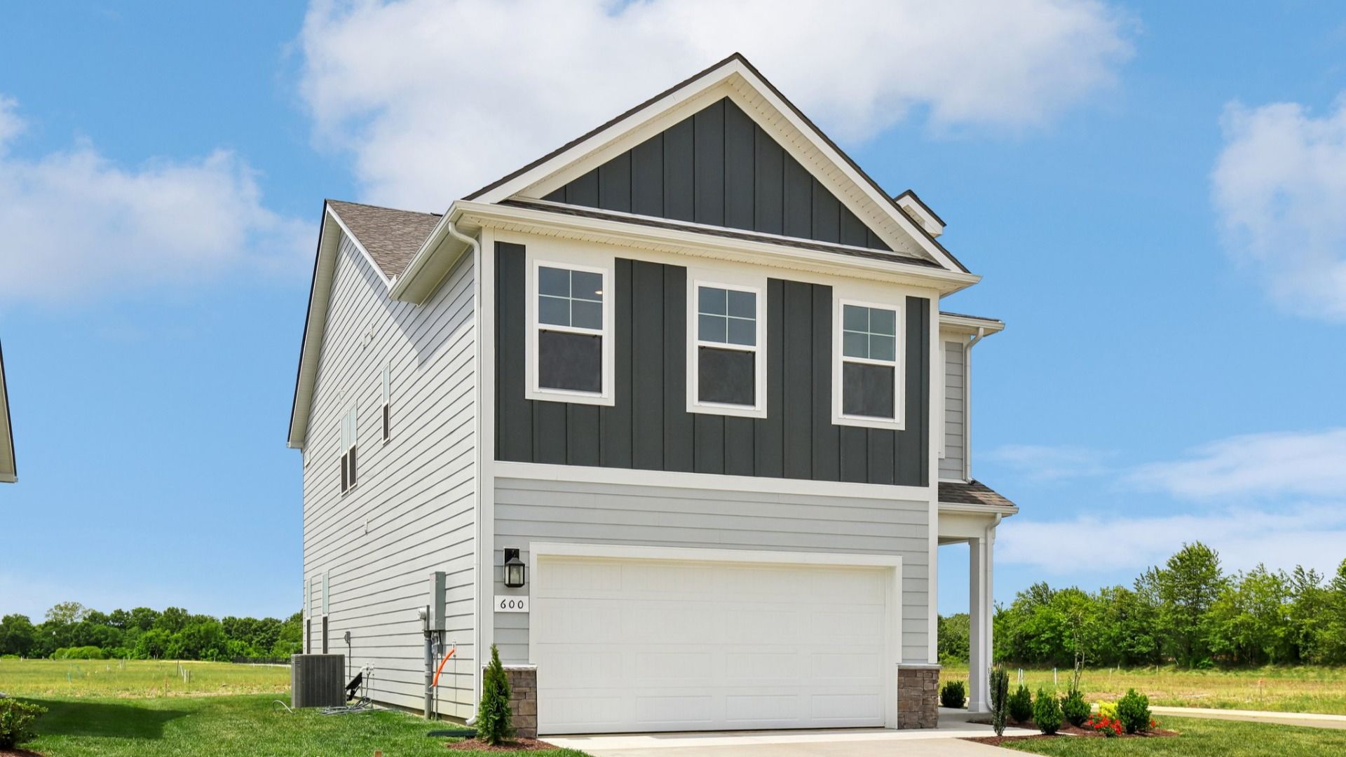 Home exterior with two tone blue siding and 2-car garage