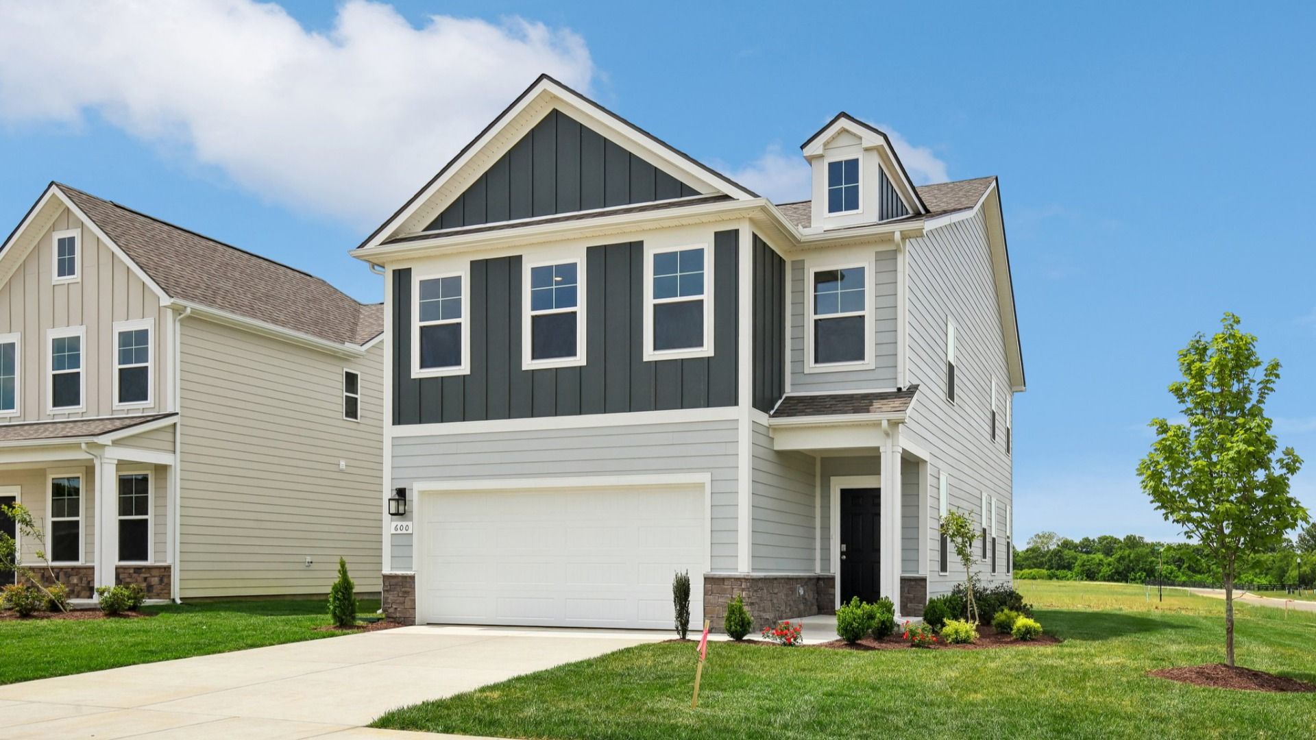Home exterior with two tone blue siding and 2-car garage