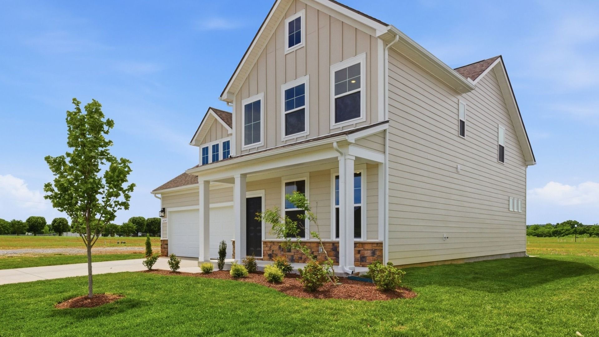 Home Exterior with two types of paneling and two car garage