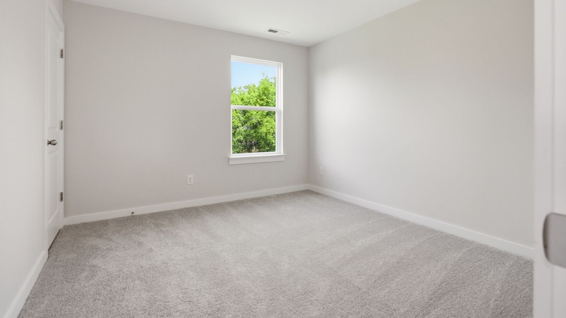 Bedroom with carpet and window