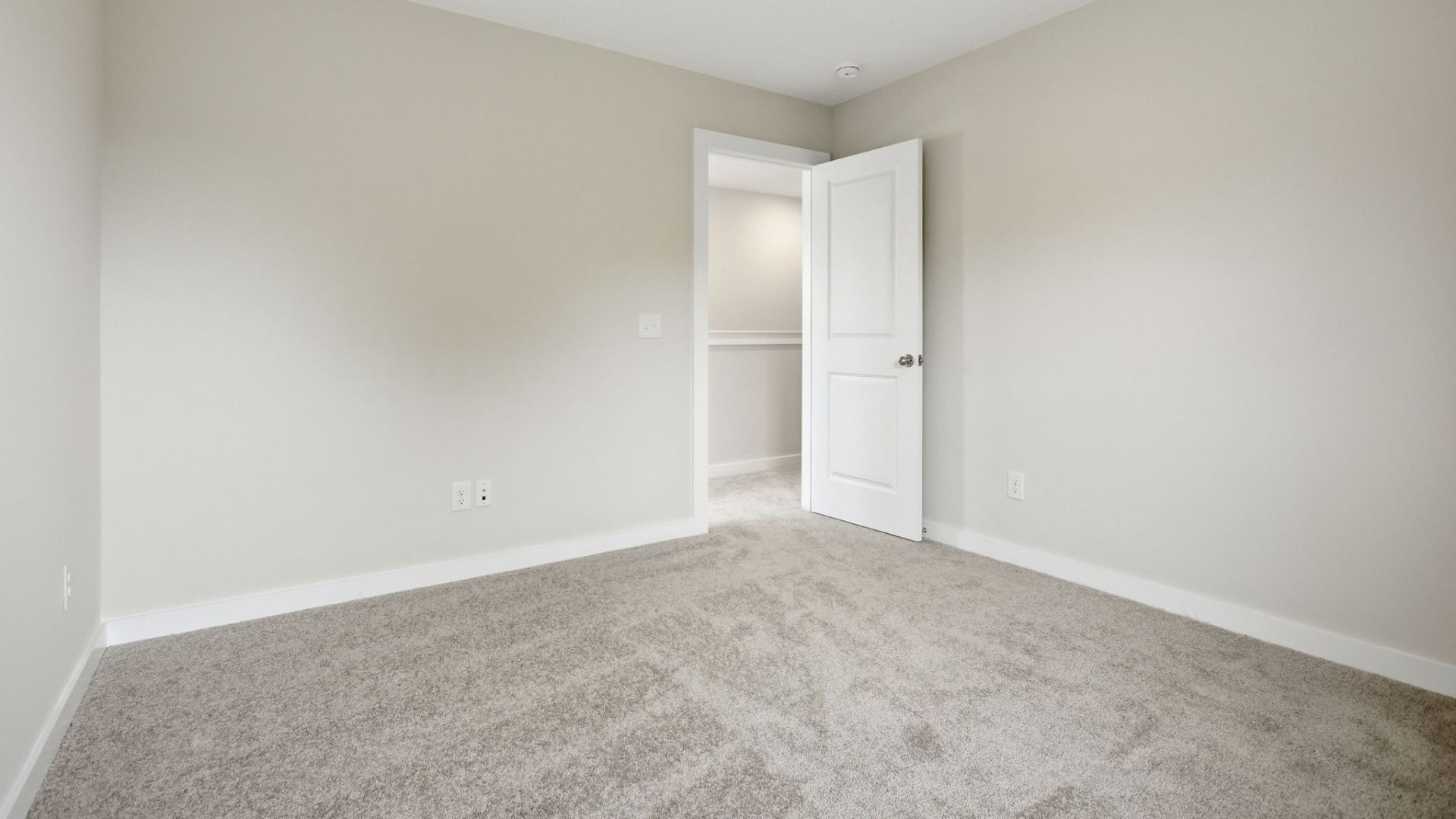 Bedroom with carpet and nearby stairs
