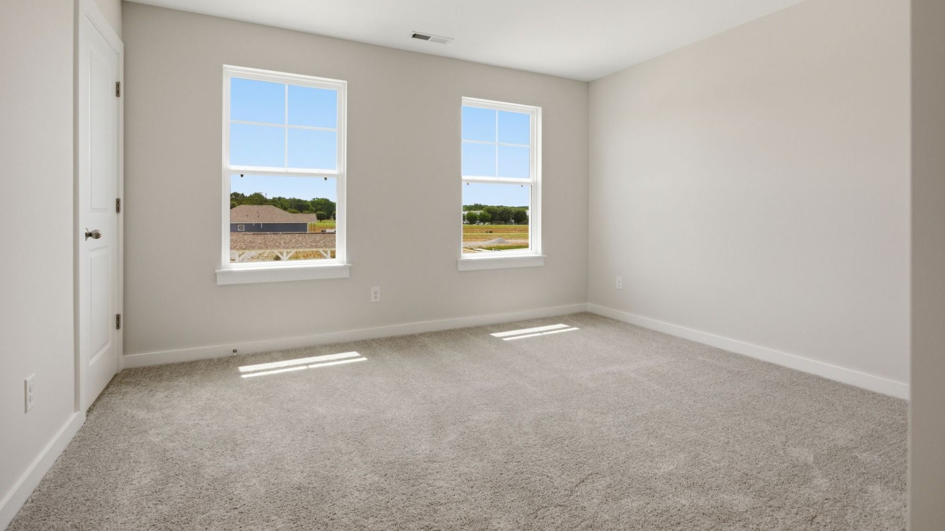 Bedroom with carpet and windows