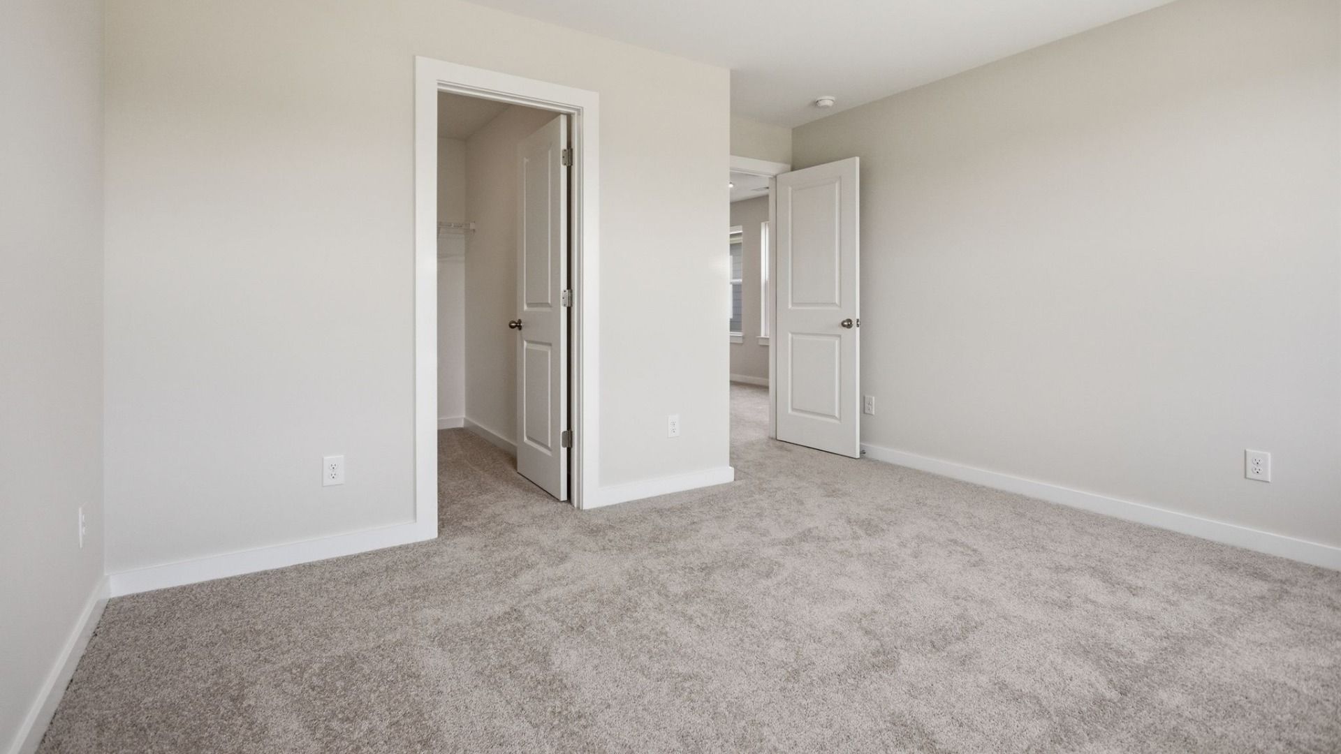 Bedroom with carpet and walk-in closet