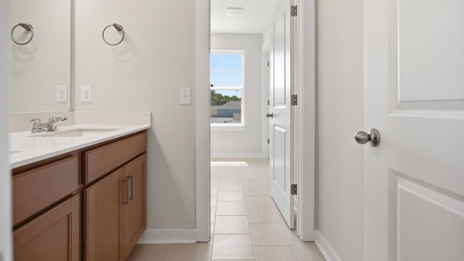 Bathroom with dual vanity and window