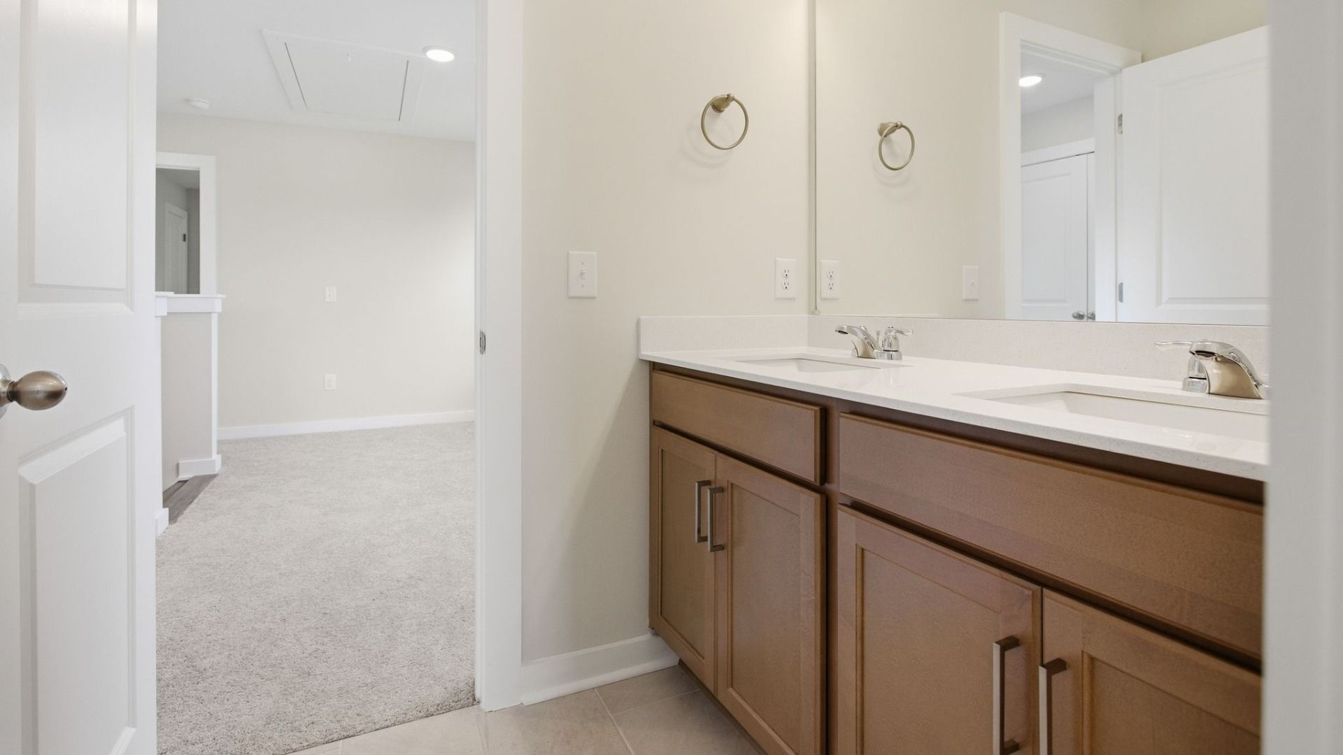 Bathroom with dual vanity and access to second floor