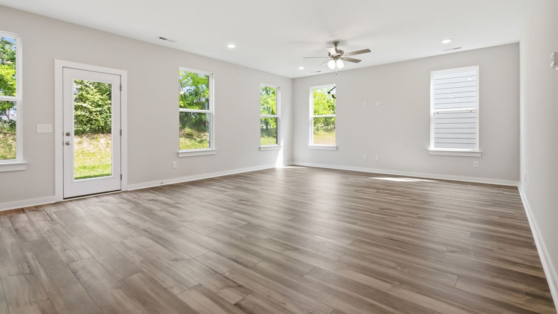 Gathering room with hard surface flooring and bright natural light through windows