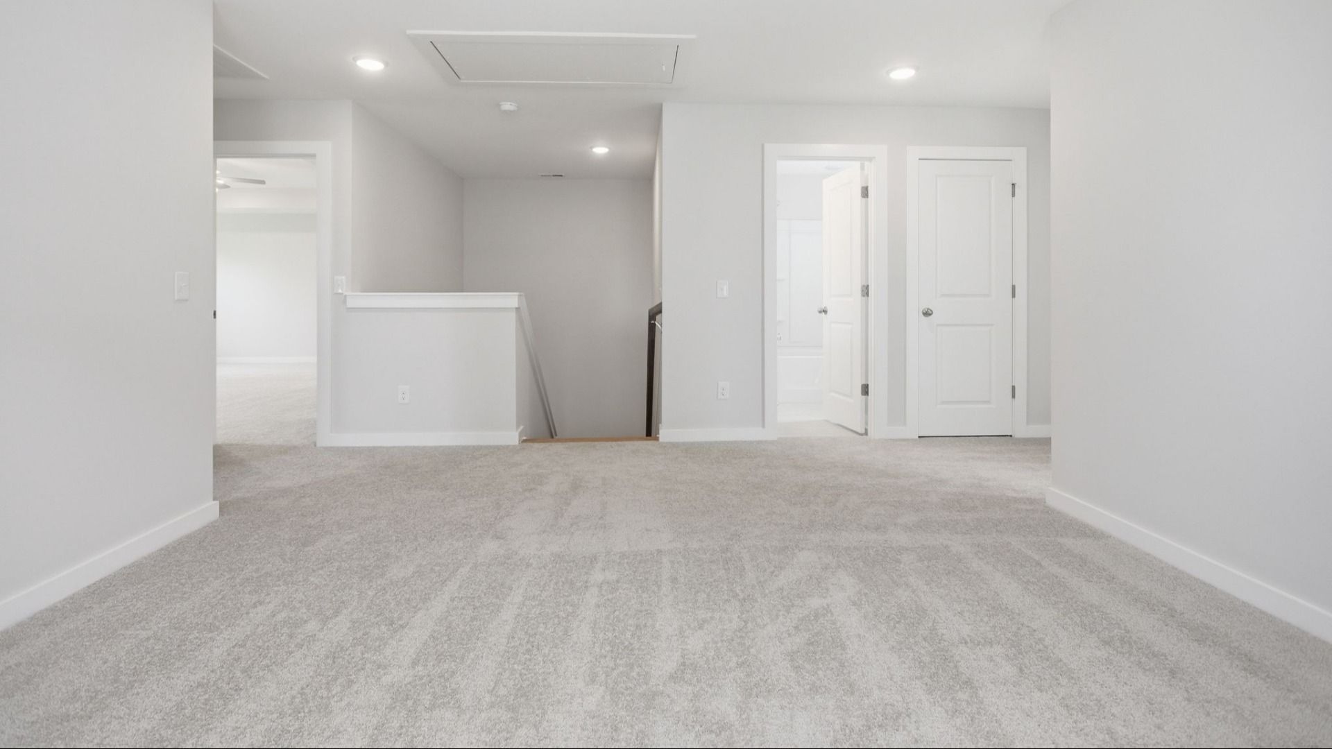 Second Floor Loft area with view of stairs with access to secondary bathroom, closet, and primary suite