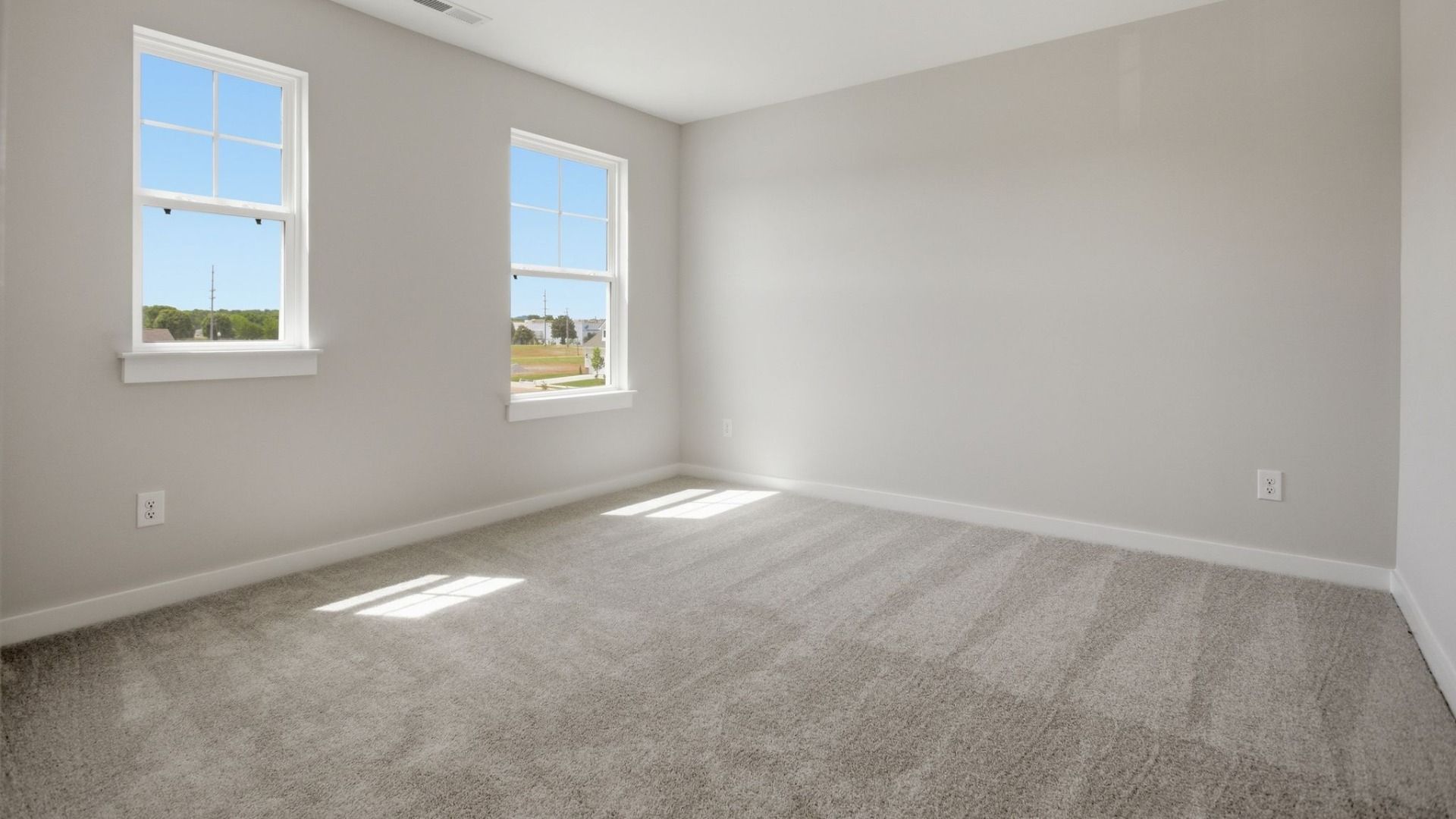Bedroom with carpet and windows