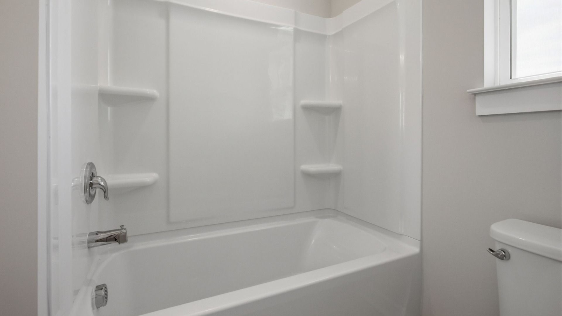 Bathroom with shower, toilet, and window