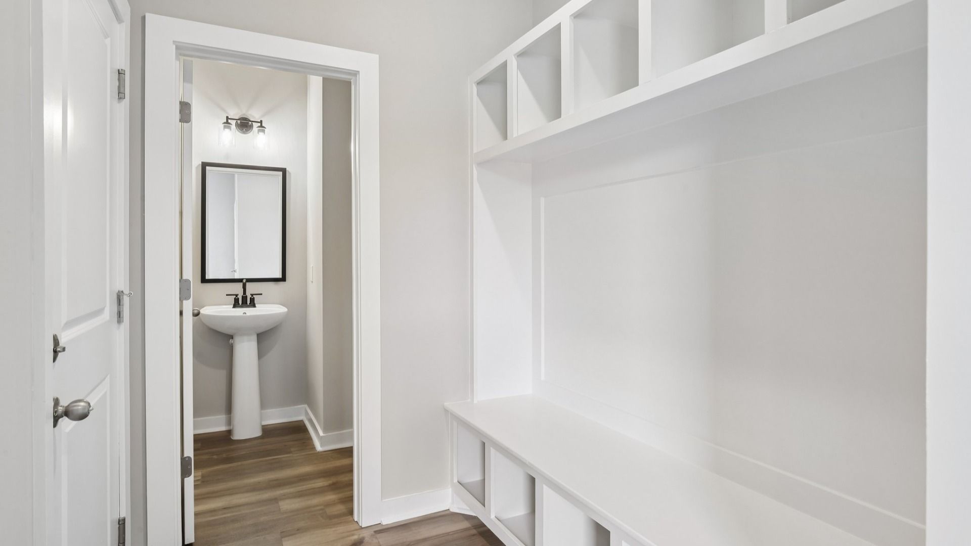Powder room and built-in drop zone near front entry
