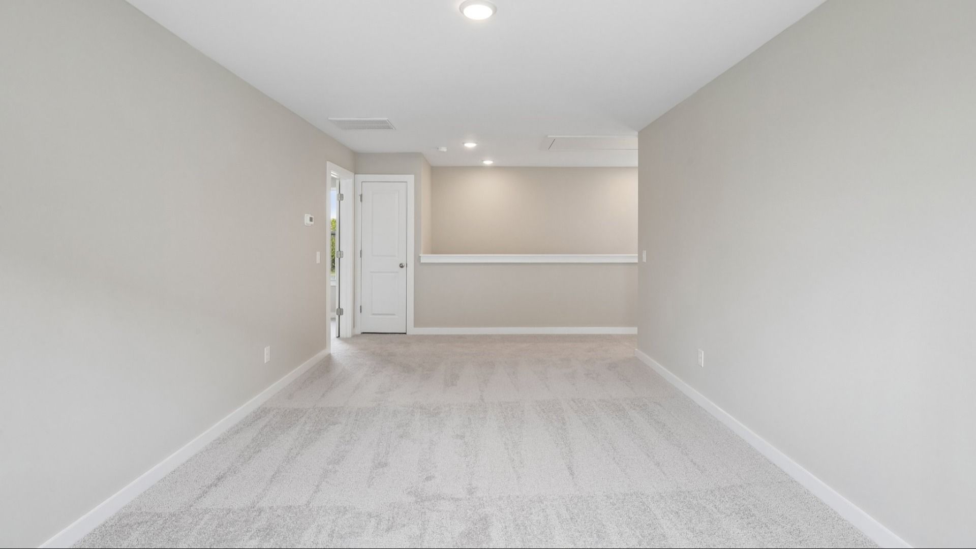 Second Floor Loft area with view of stairs and carpet