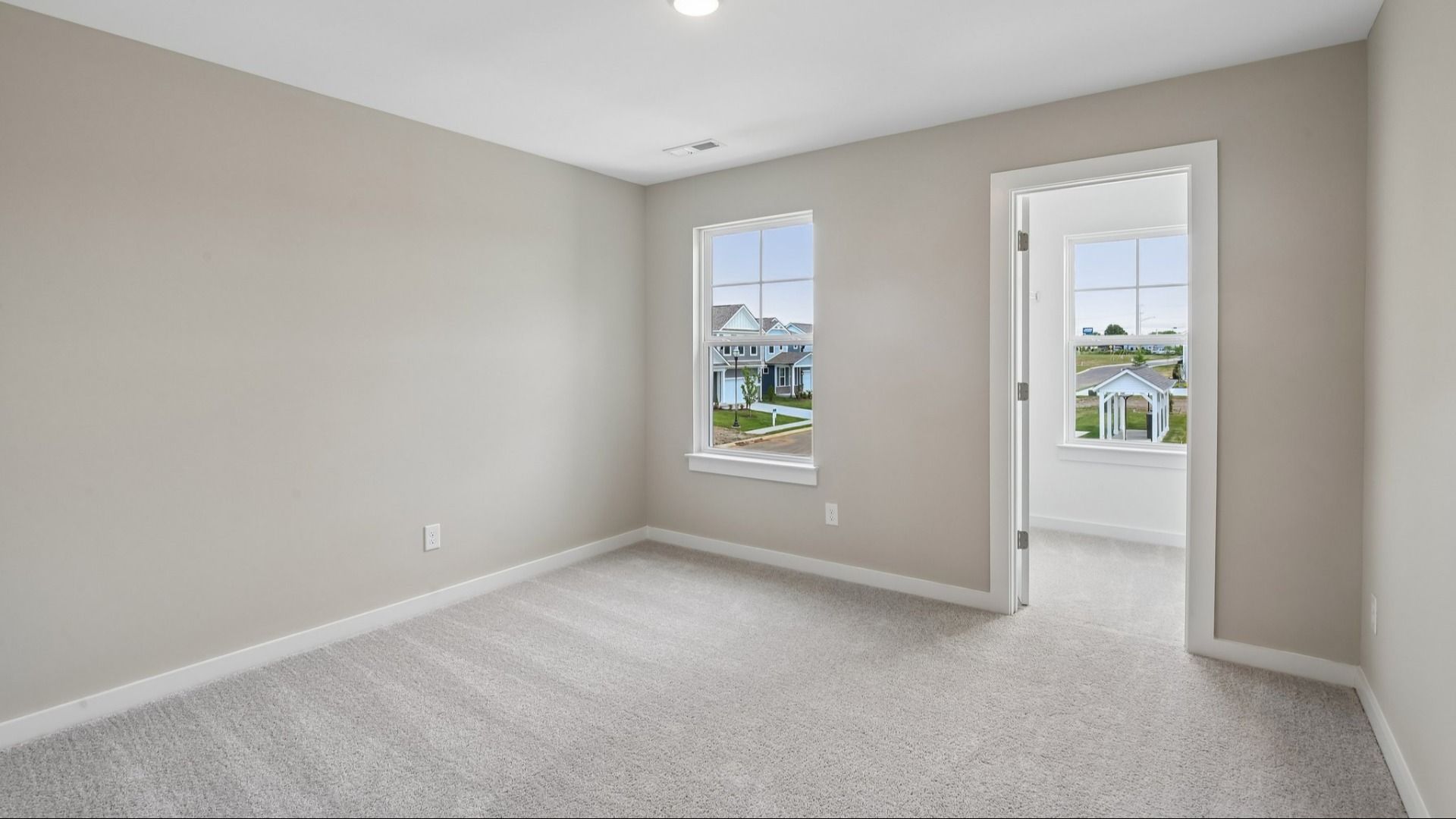 Bedroom with walk-in closet and window
