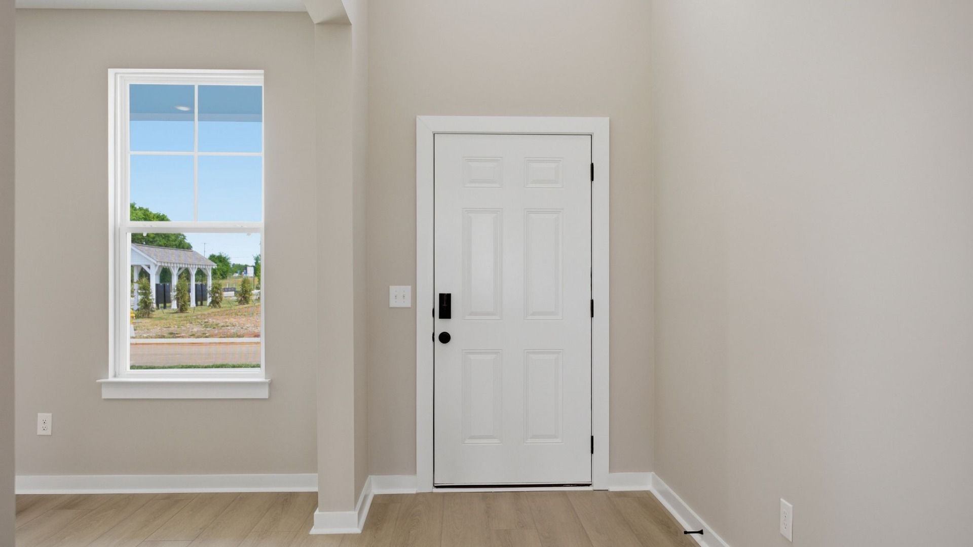 Front door to home with nearby window