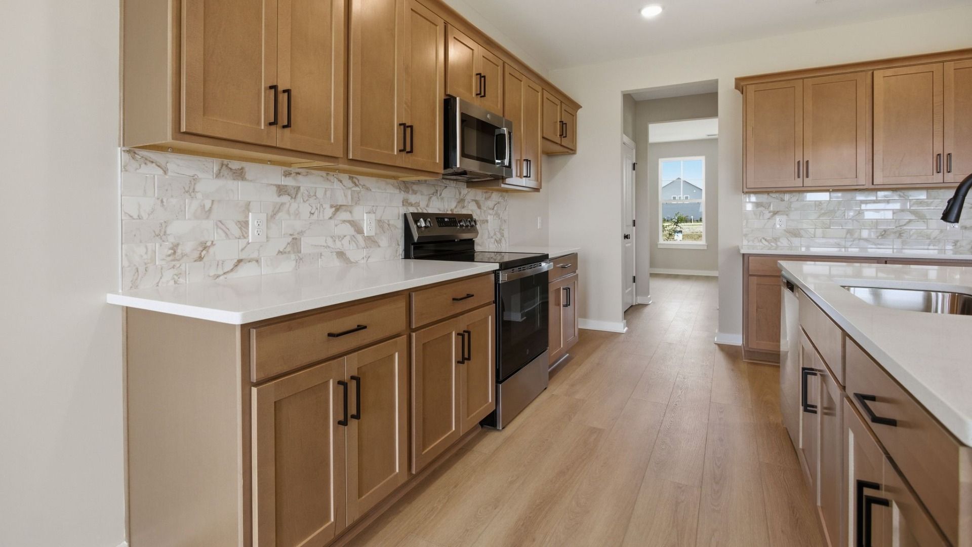 Kitchen with quartz countertops, tile backsplash, and view of flex room