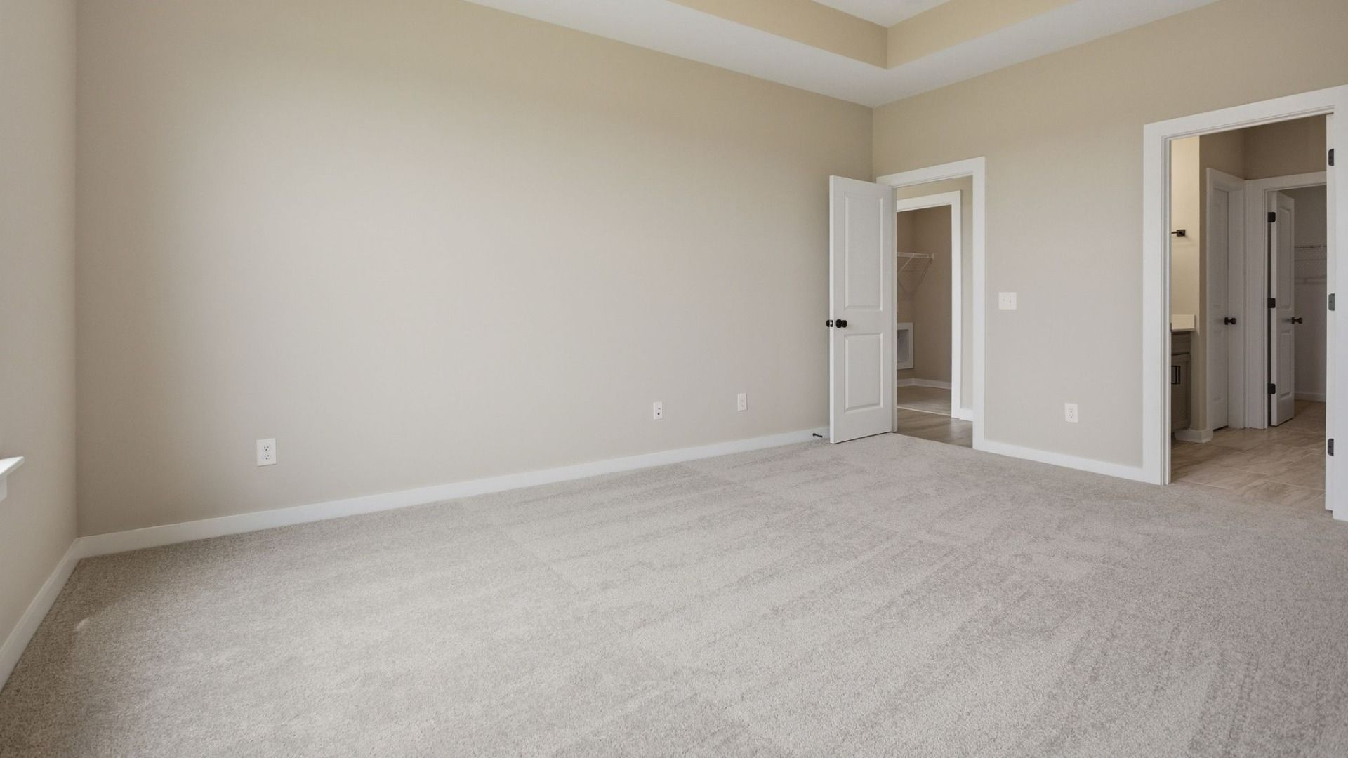 Bedroom with access to primary bathroom, closet, and gathering room