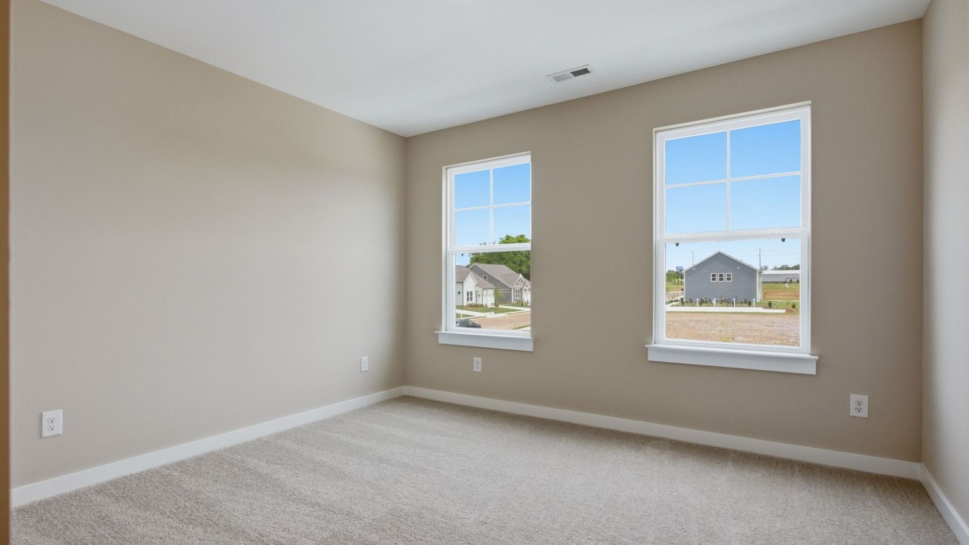 Bedroom with carpet and windows