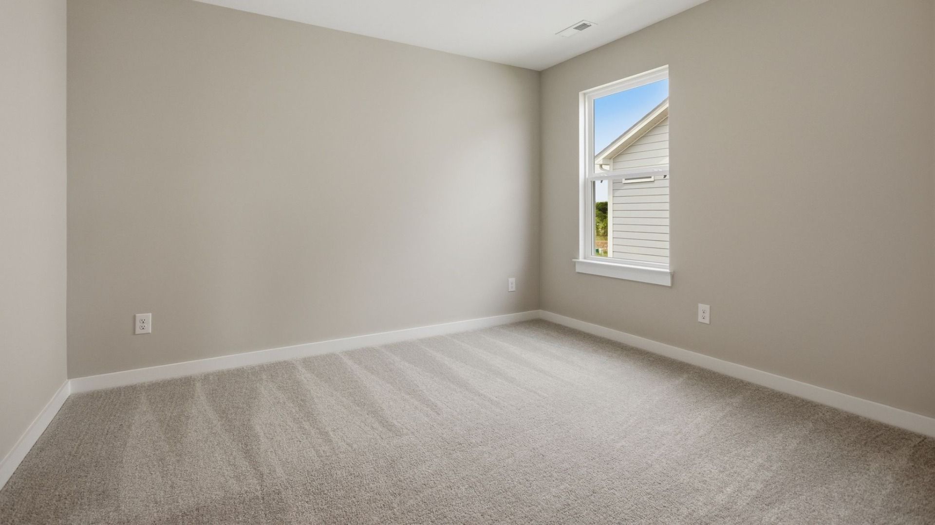 Bedroom with carpet and windows