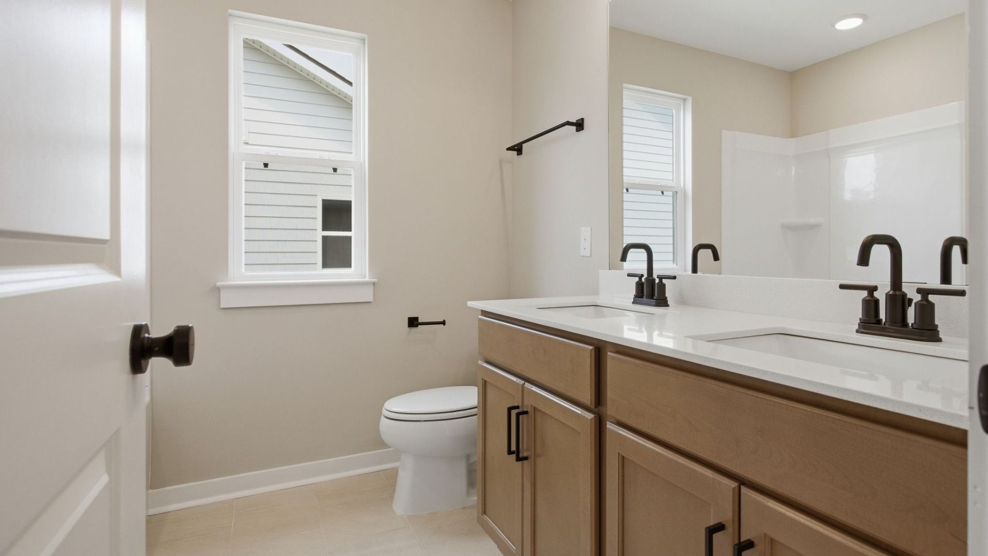 Bathroom with dual vanity and window