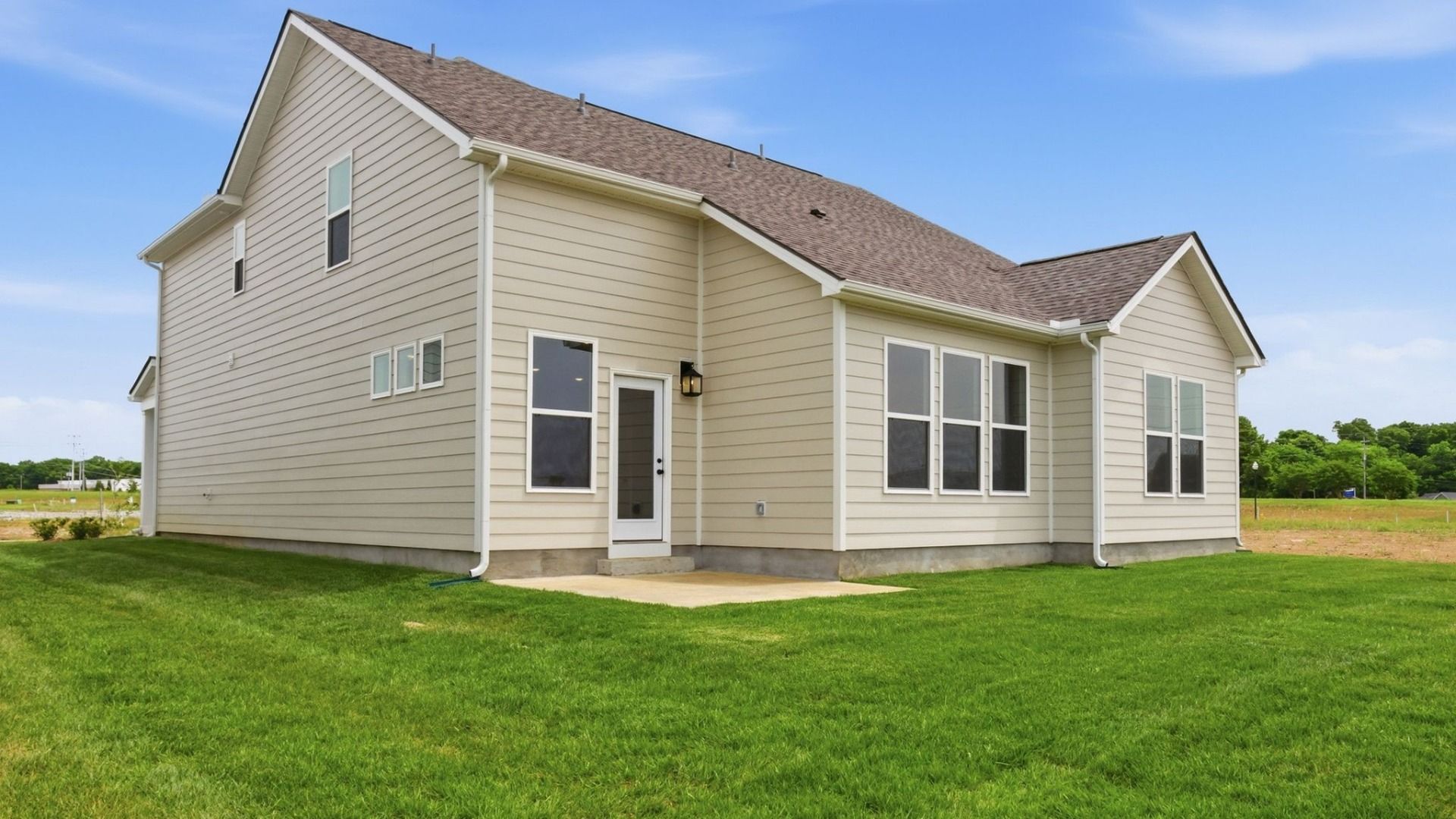 Backyard of home with small back patio