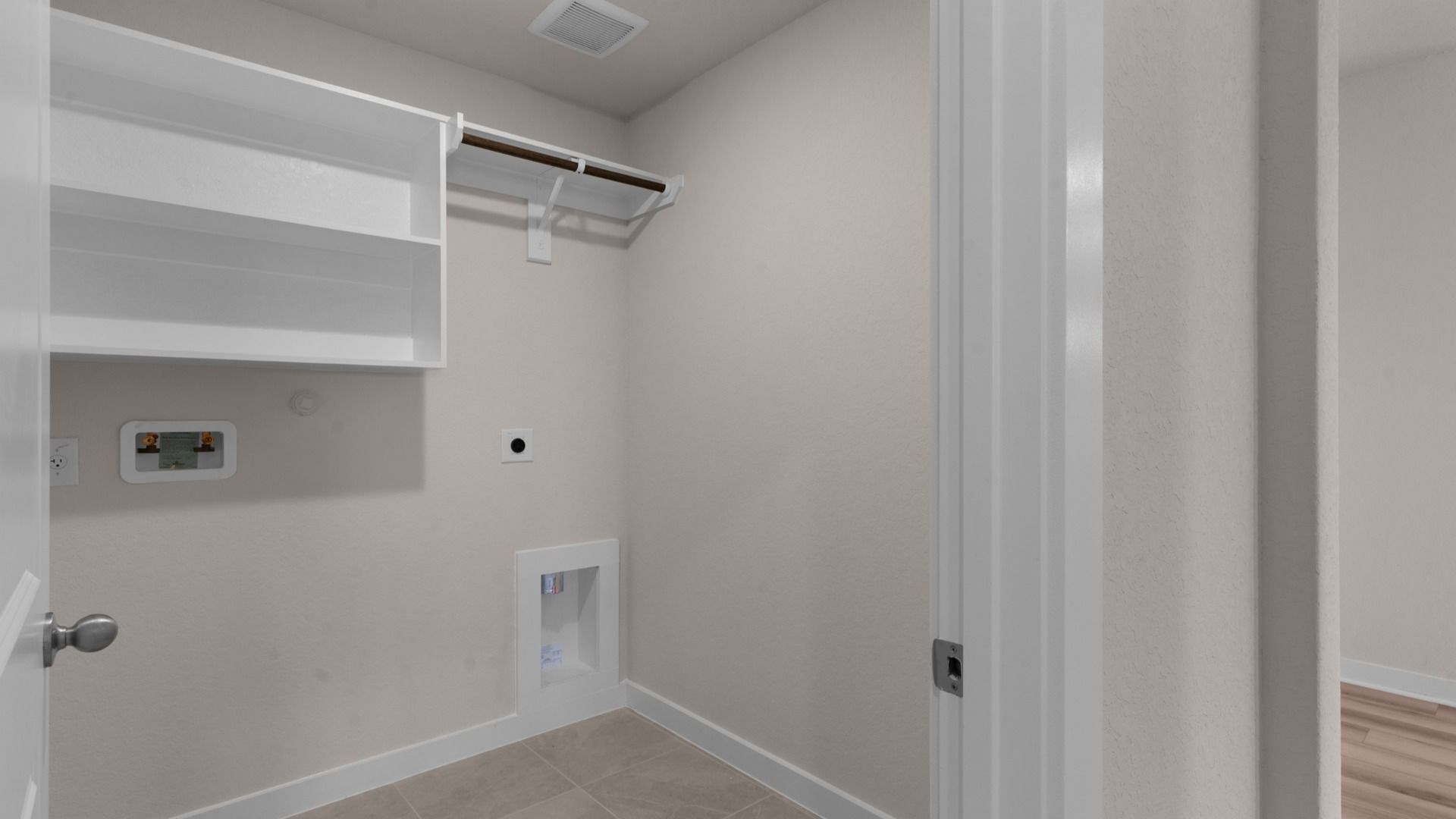 Separate Utility Room includes built-in shelving and wooden rod.