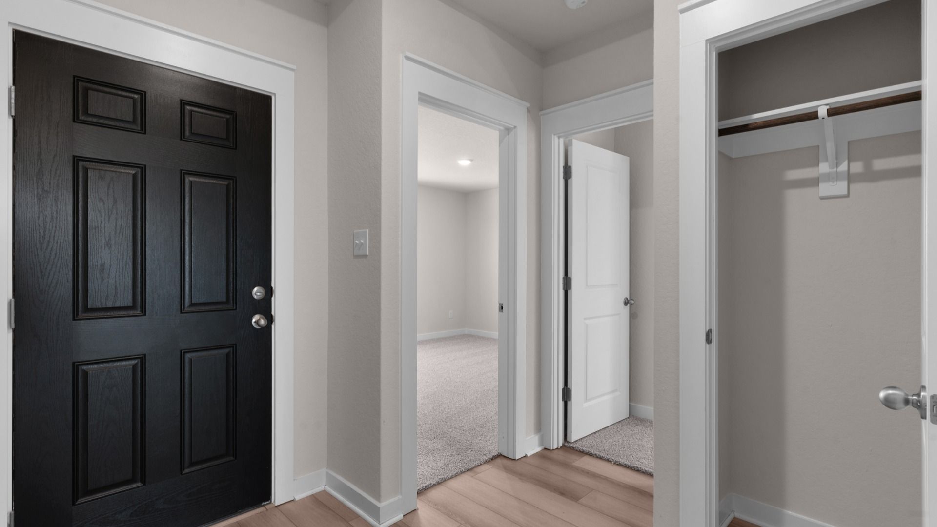 Entryway with tray ceilings and a convenient coat closet, creating a spacious and organized welcome space.