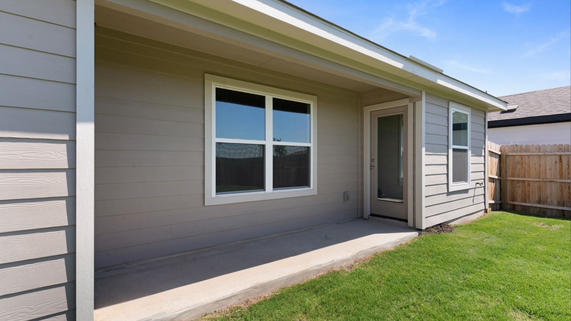 Covered patio providing a shaded outdoor living space, perfect for relaxing or entertaining year-round.