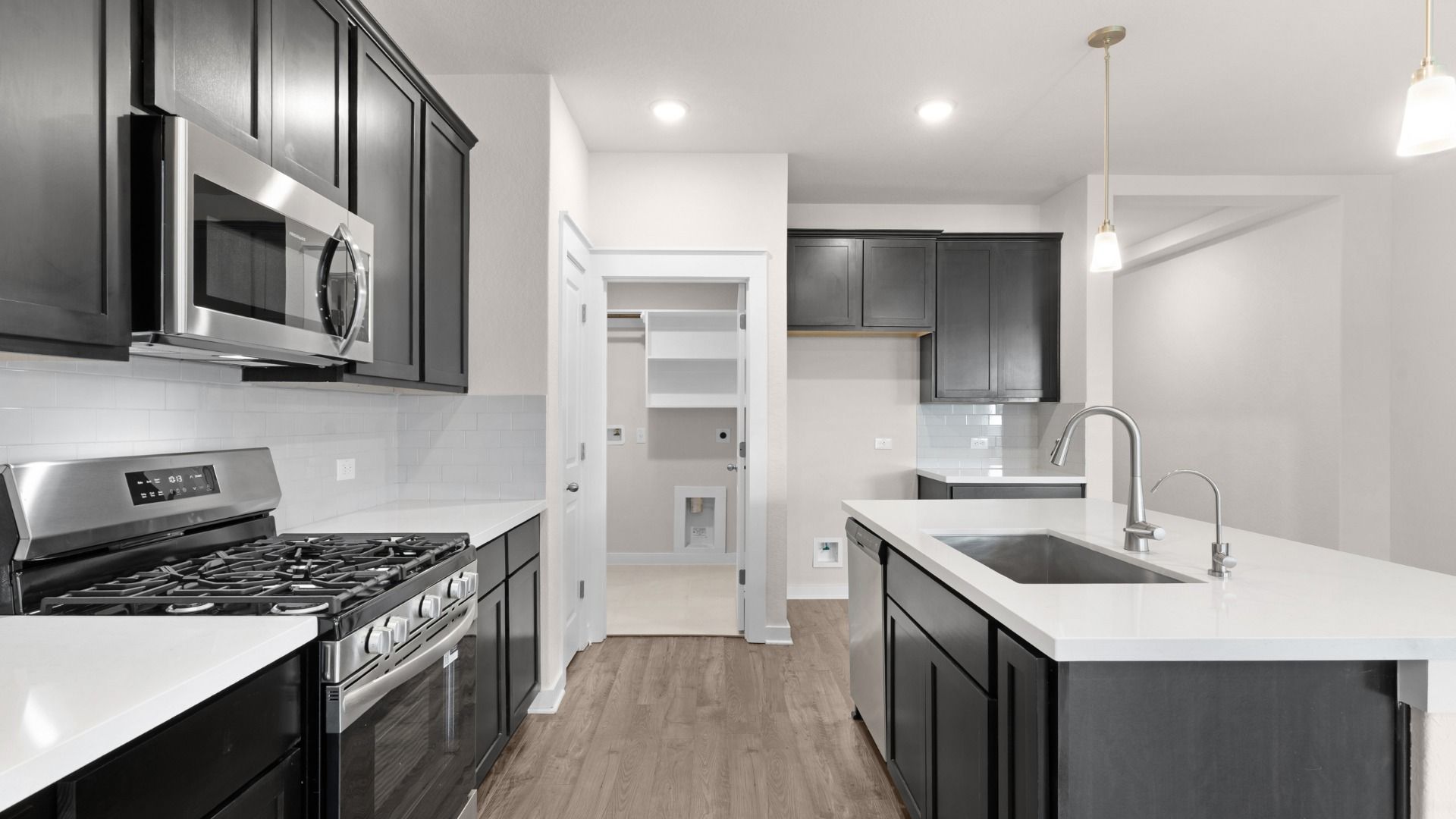 Enjoy the added convenience of Gas Cooking in the kitchen, along with a center island with sleek stainless steel sink.