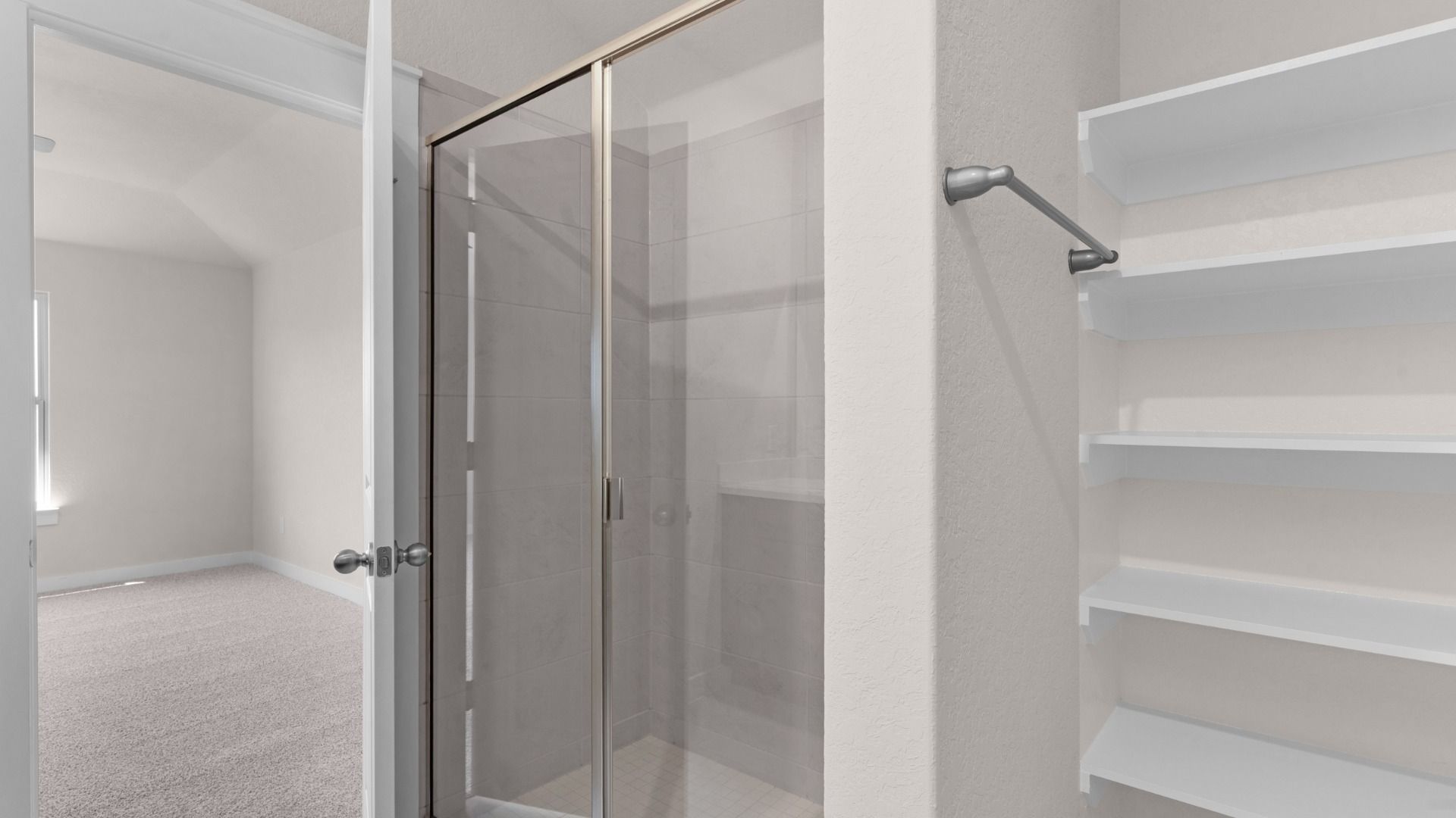 Dual vanity with, open shelving for linen storage, and a framed glass shower, blending style with practical function.