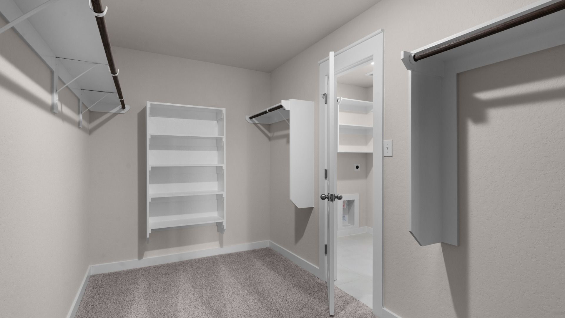 Owner's closet provides ample storage with built-in shelving and wooden closet rods.