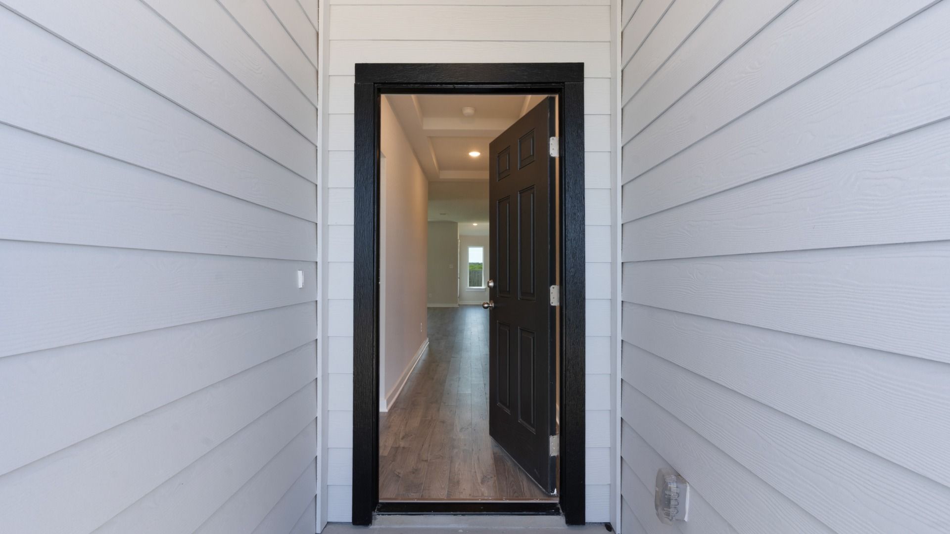 Covered front porch leading to a welcoming entryway, offering an inviting first impression.