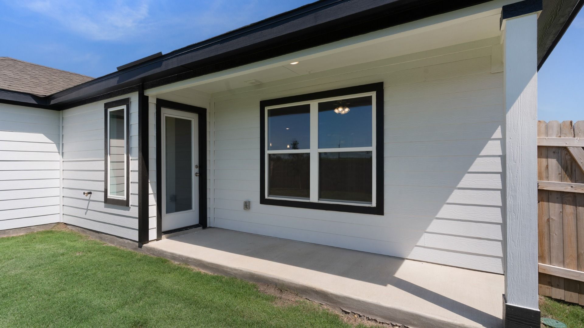 Covered patio providing a shaded outdoor living space, perfect for relaxing or entertaining year-round.