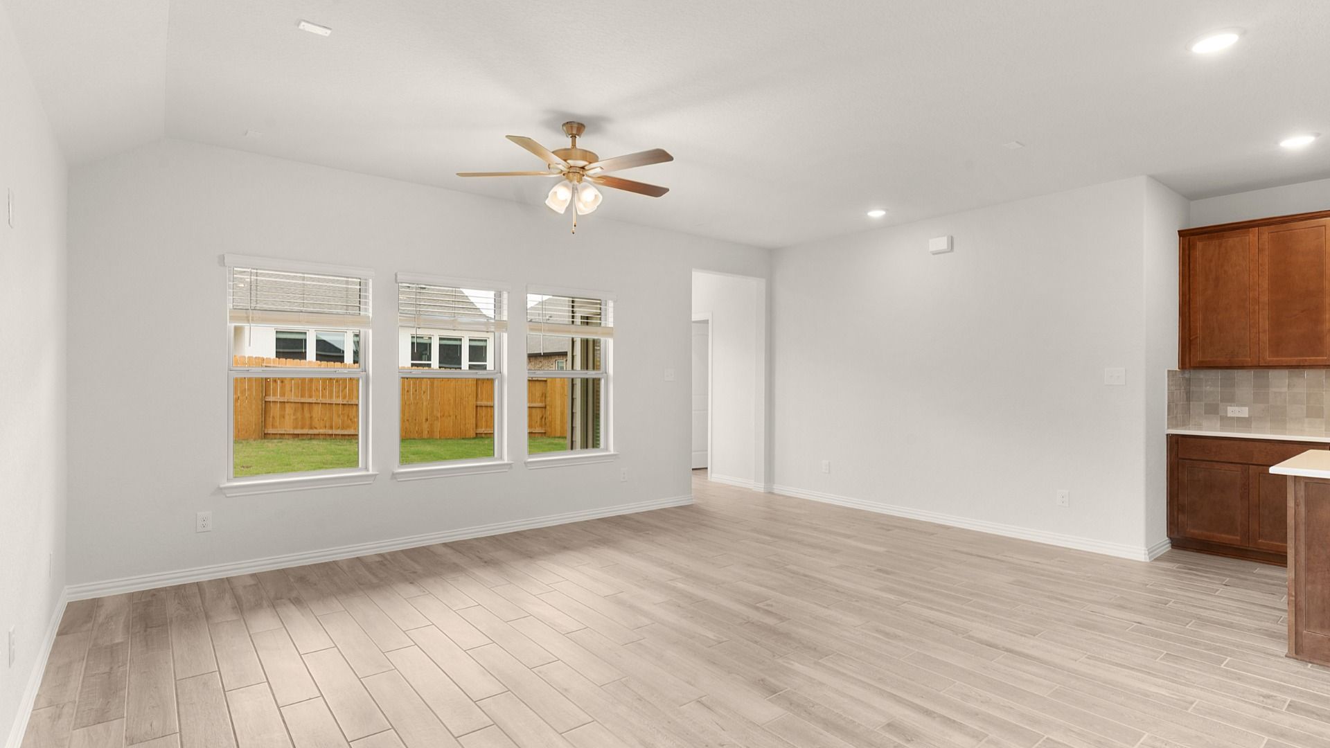 Great room opens to kitchen and dining with a ceiling fan, creating a comfortable, connected living space.