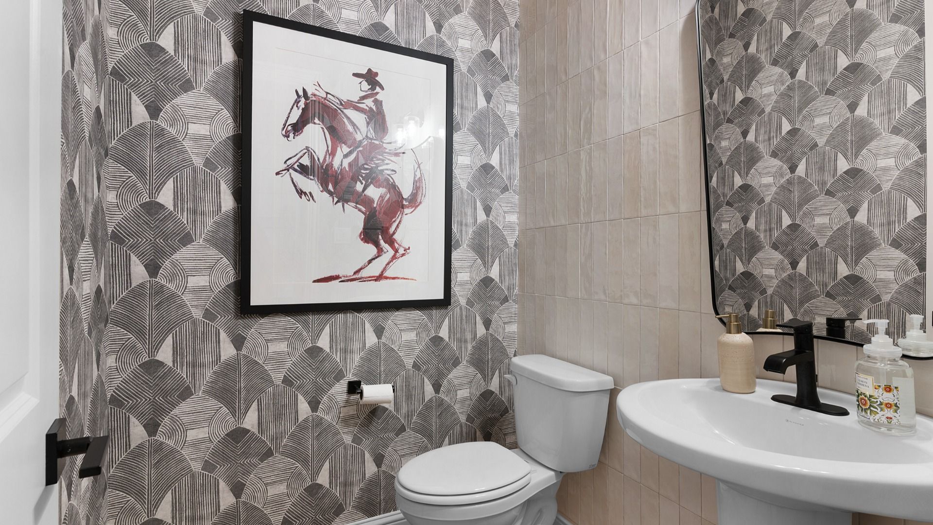 Stylish powder room near the entryway with modern finishes and convenient guest access.