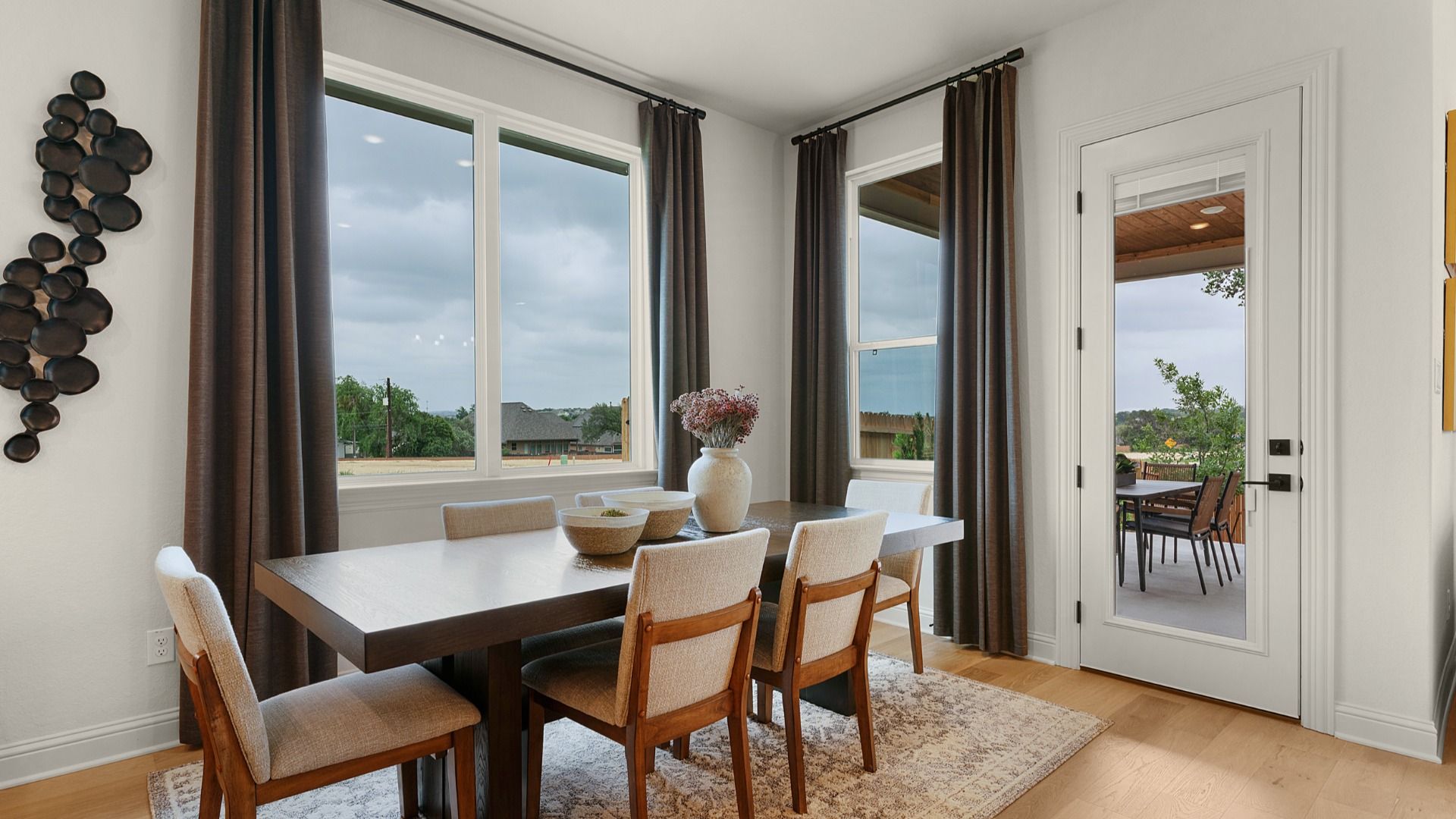 Casual dining area overlooking the covered patio with abundant natural light.