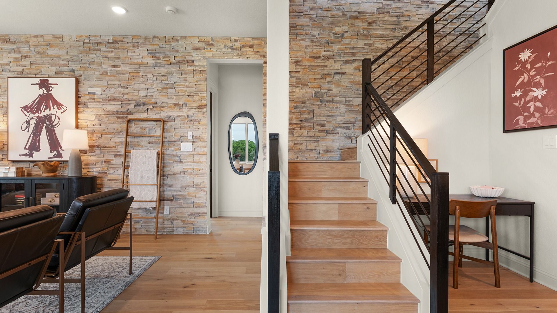 Sleek warm-toned staircase with a modern black railing creates an architectural statement.