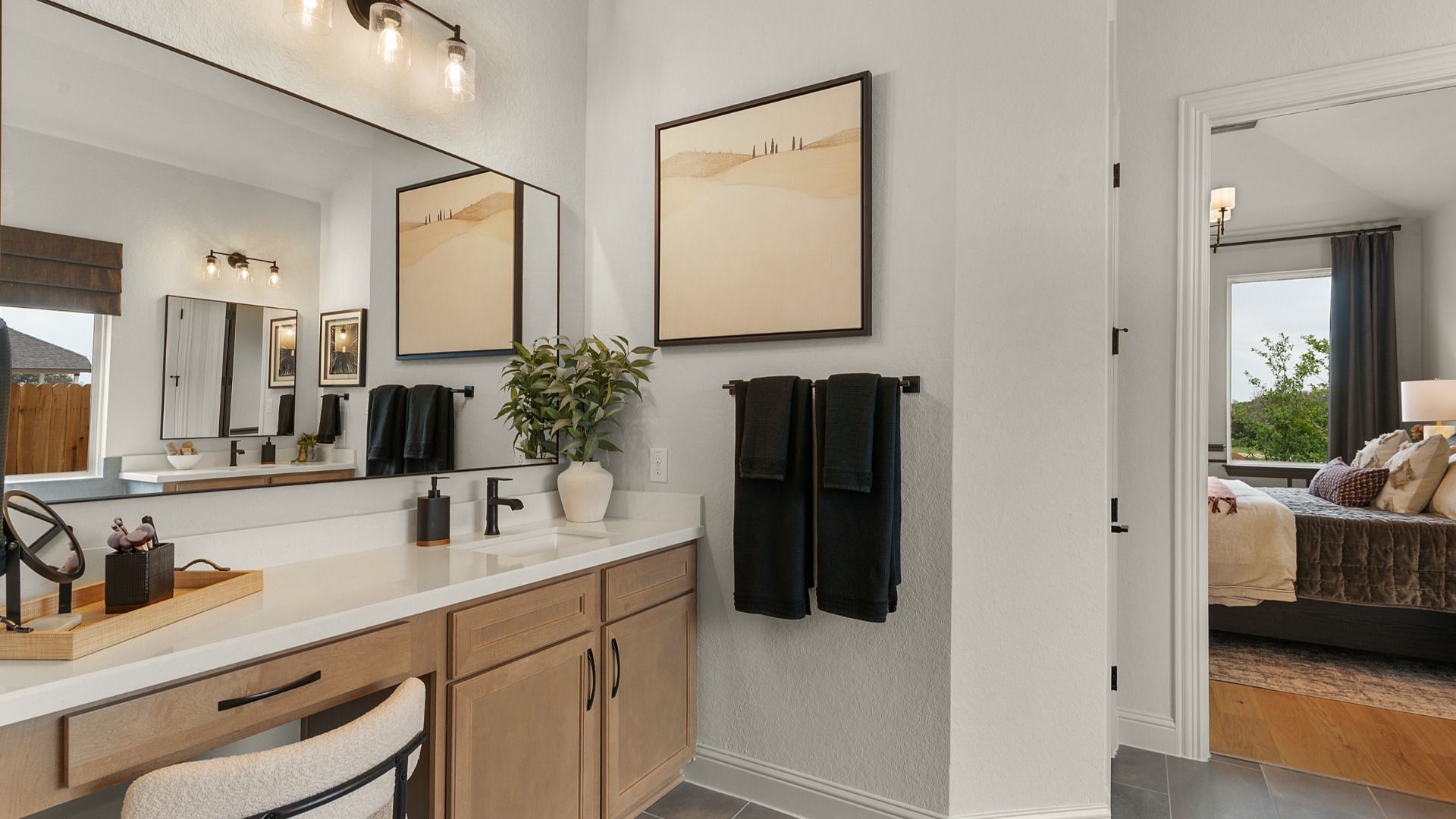 Owner’s bathroom features a true vanity detail with space for a chair, combining function and elegance.