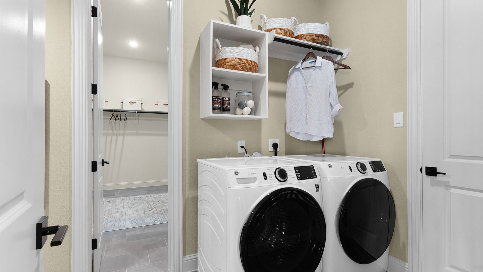 Laundry room with convenient access to the owner’s closet, featuring a functional and well-connected layout.