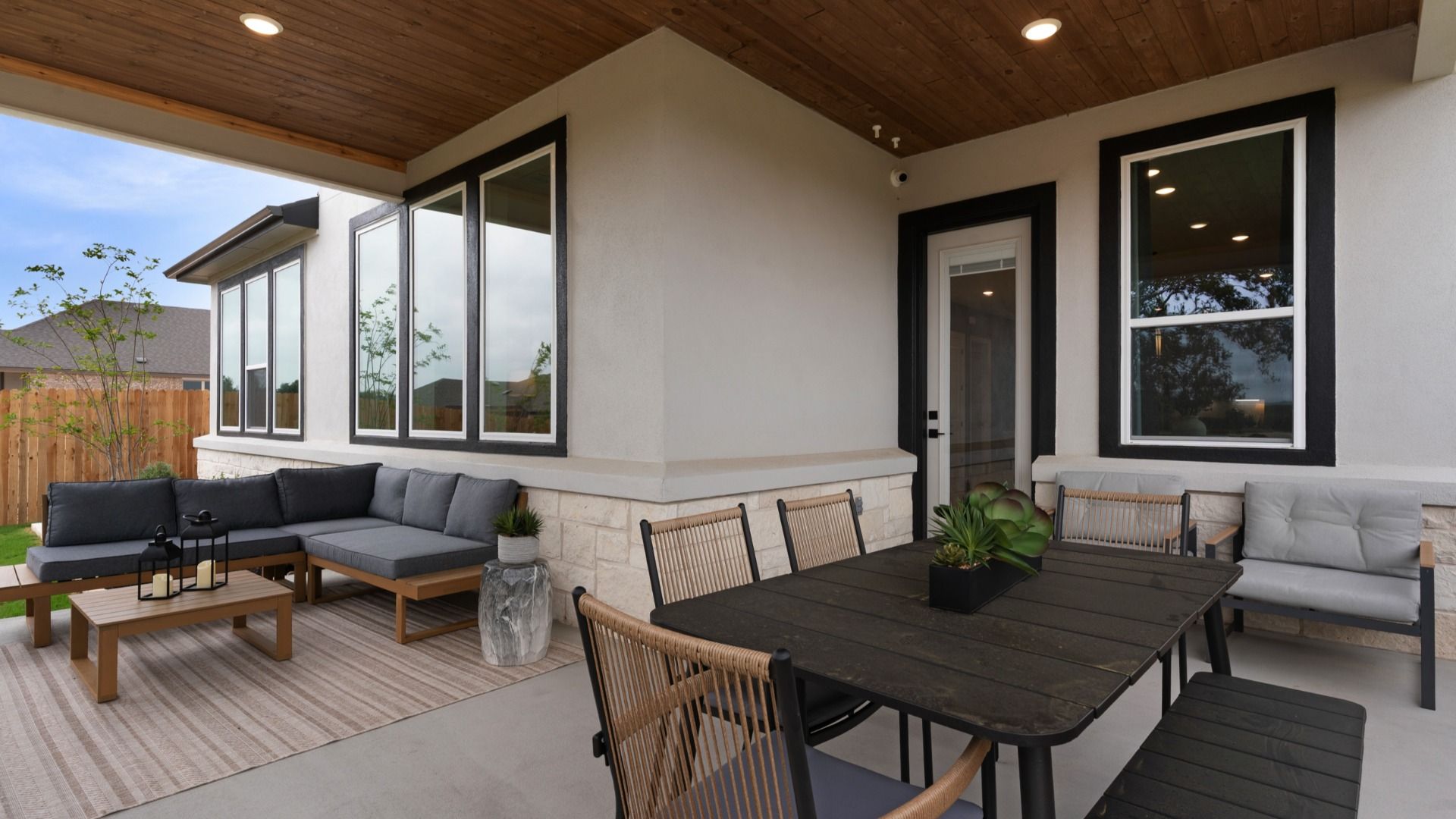 Inviting backyard with large covered patio and refined landscaping details.