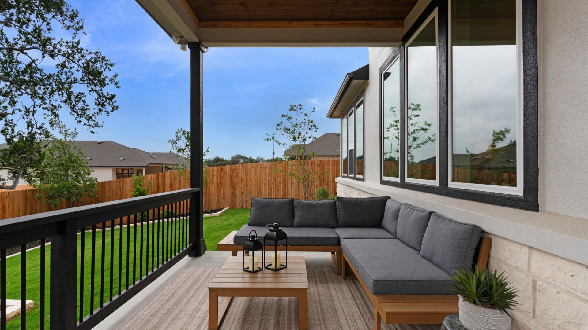 Inviting backyard with large covered patio and refined landscaping details.