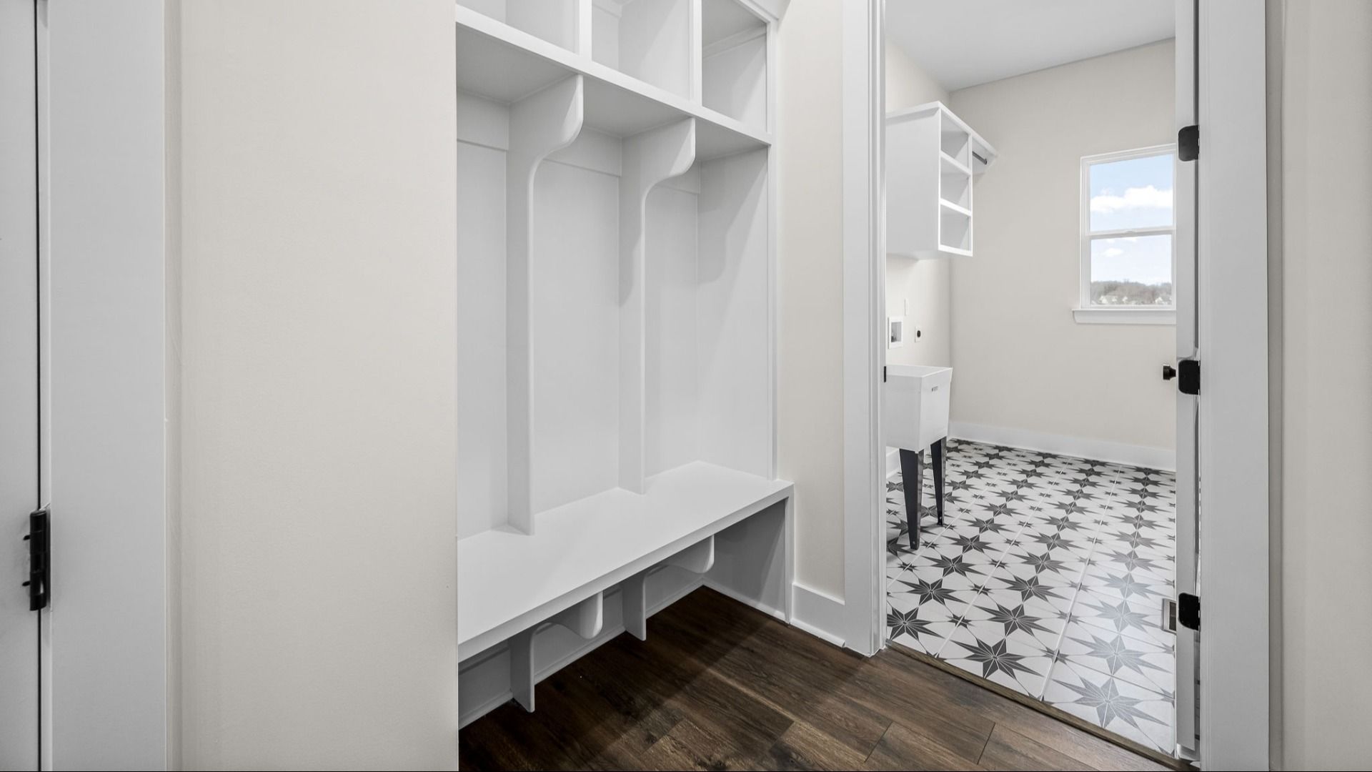 Beautiful Drop-zone and dedicated laundry room including specialty floor, window, and sink.