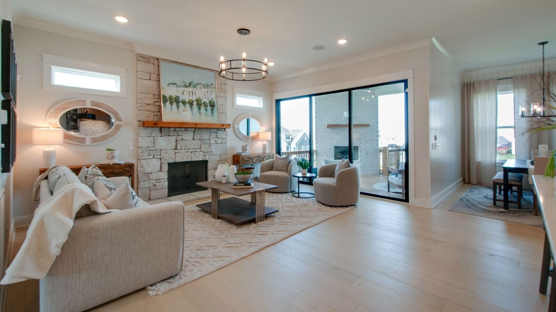 Gathering room with fireplace, natural lighting, and beautiful view of back porch