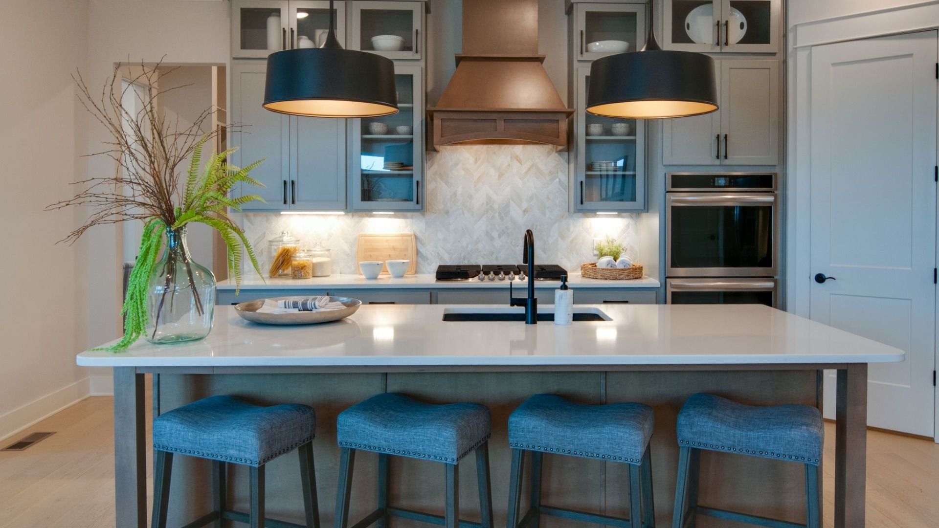 Kitchen with pendant lighting, quartz countertops, and tile backsplash