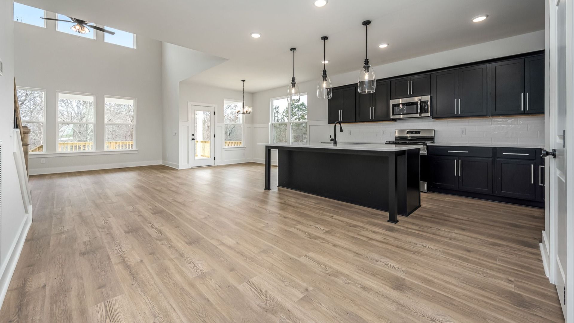 First floor open concept with sleek kitchen design and high ceilings