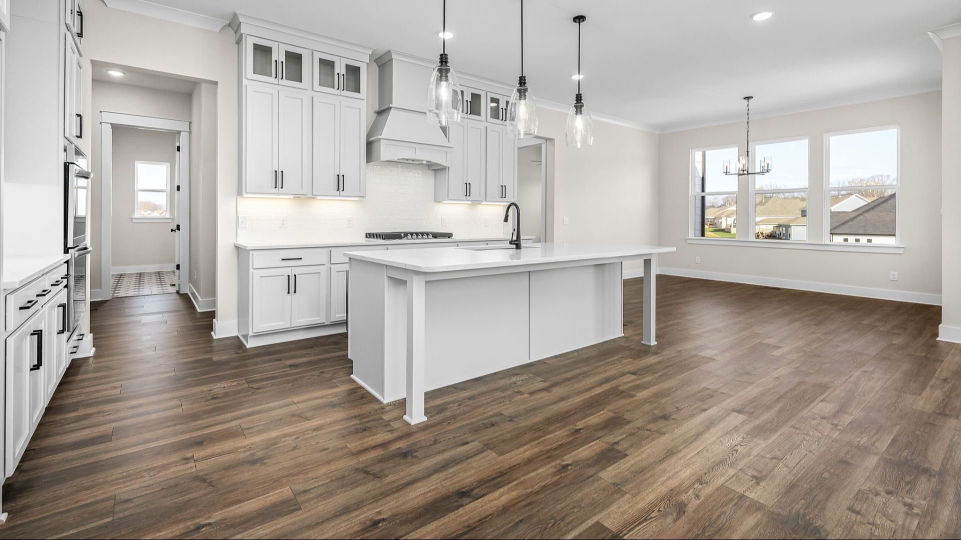Kitchen and dining area with hard surface flooring and naturally bright from windows