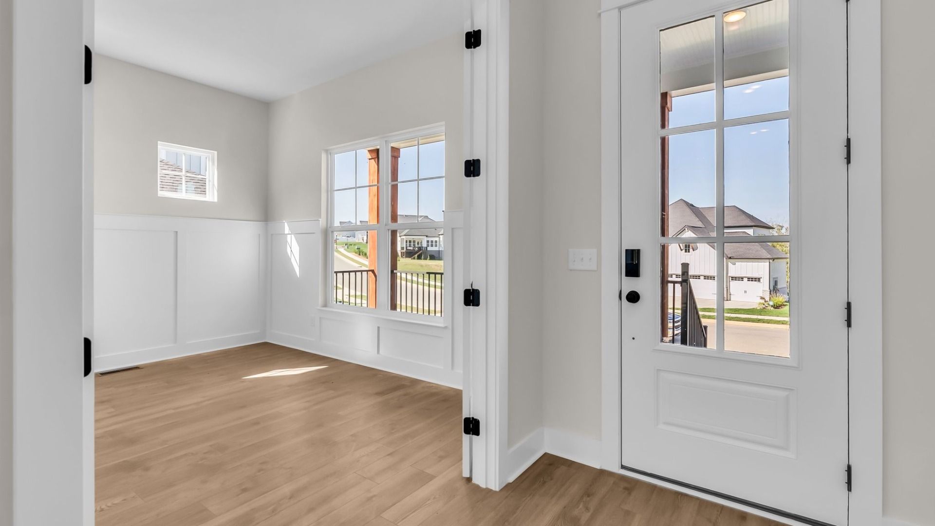 Front entryway with spacious study and bright natural lighting from windows and French door