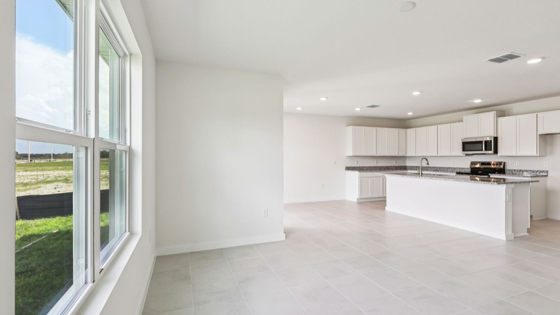 Dining Area and Kitchen of the Baker Floor Plan by DRB Homes in Liberty Trace New Homes in Haines City