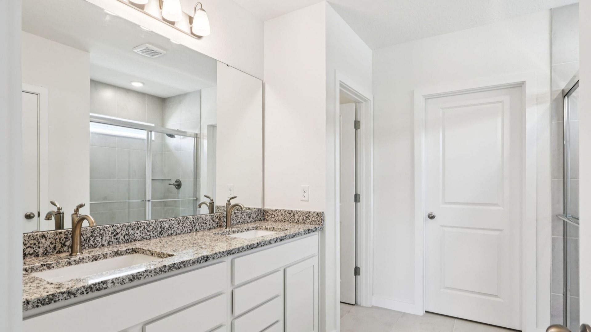Primary En Suite Bath of the Baker Floor Plan by DRB Homes in Liberty Trace New Homes in Haines City