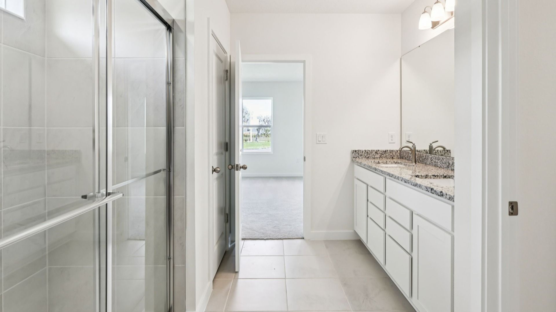 Primary En Suite Bath of the Baker Floor Plan by DRB Homes in Liberty Trace New Homes in Haines City